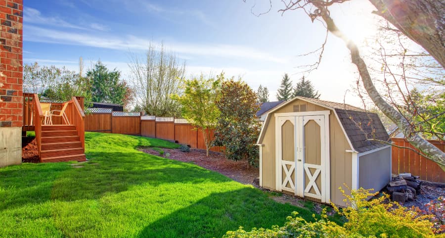 Fenced backyard with storage shed in Flint